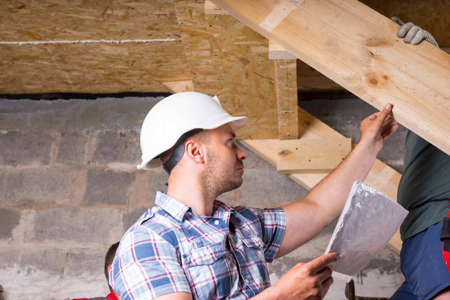 Foreman Inspecting Work on Staircase in New Home
